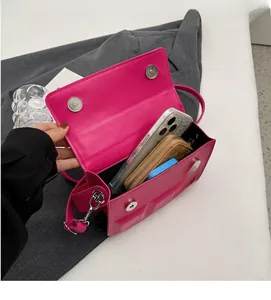 Interior view of the hot pink crossbody bag showing capacity for phone and wallet