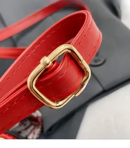 Detailed close-up of premium red leather strap with shiny gold buckle and precise stitching