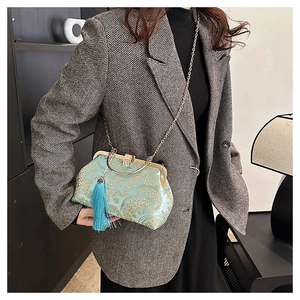 Detail of light blue brocade handbag with golden floral embroidery and blue silk tassel