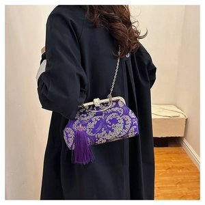 Detail of purple silk brocade handbag with floral embroidery and elegant long tassel