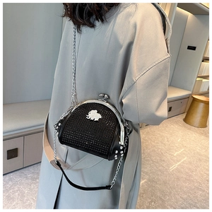 Detail of black shell crossbody bag with silver elephant logo and studded rhinestones