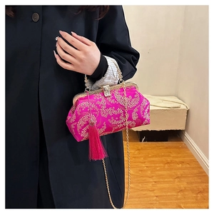 Détail de la broderie florale rose sur ce sac à main Qipao élégant avec pompon