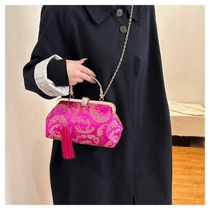 Detail of rose red brocade handbag with golden floral embroidery and silk tassel