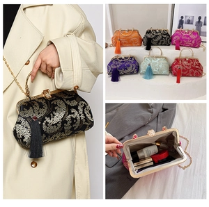 Detail of embroidered silk handbag showing interior capacity and colorful tassel accents
