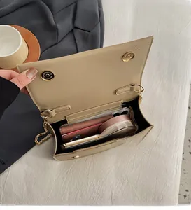 Top view of beige leather crossbody bag interior showing spacious capacity for essentials