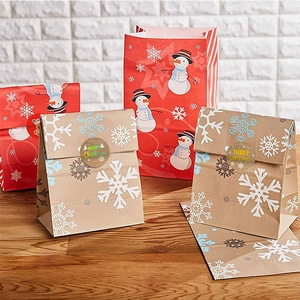 Kraft paper Christmas gift bags with snowflake snowman patterns and gold seal stickers