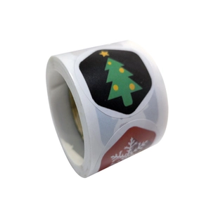 Roll of assorted Christmas stickers featuring green trees and white snowflakes on red background