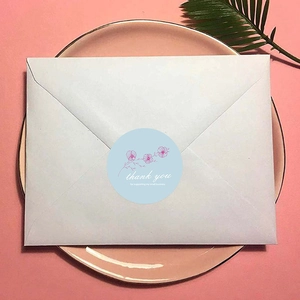 Blue floral thank you stickers for small business gift packaging on a white envelope