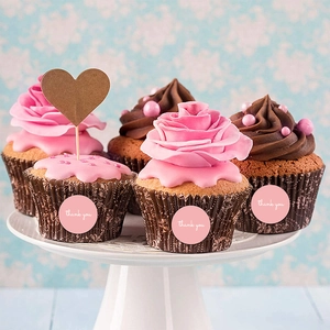 Pink round Thank You stickers on cupcakes with floral background for gift packaging