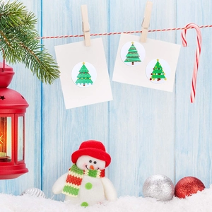Christmas tree decorative round stickers displayed on a festive blue wooden background