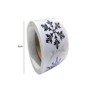 Roll of 6cm round Christmas snowflake stickers for holiday gift packaging seals
