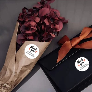 White round Thank You stickers with red hearts on kraft gift box and flower bouquet