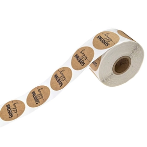 Roll of kraft paper Happy Holidays stickers with black paw print for gift wrapping