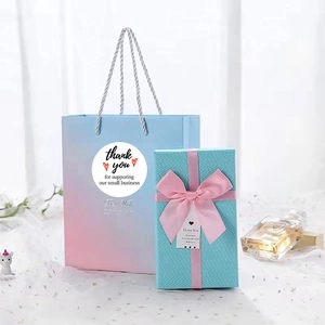 White Thank You stickers with red hearts on gift bags and blue woven texture boxes