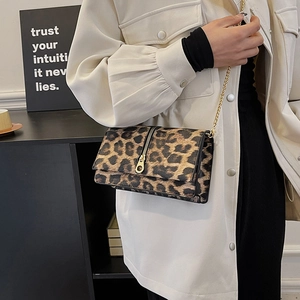 Chic leopard print crossbody bag with gold chain strap and large zipper detail