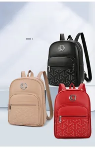 Detailed view of women's backpacks in black, beige, and red with geometric stitching
