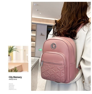Pink quilted backpack with Y-shaped embroidery and metal G logo shown on model back