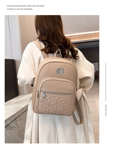 Close-up of beige minimalist backpack with geometric quilting and metallic logo on back