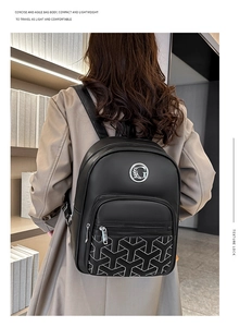 Detail of black backpack showing geometric quilting and metal G logo on a model