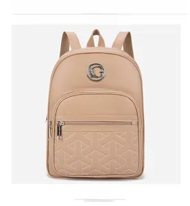 Detailed view of beige faux leather backpack featuring geometric Y-shaped stitching and G logo