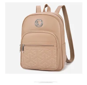 Detail of beige faux leather backpack showing G logo and Y-shape geometric quilting