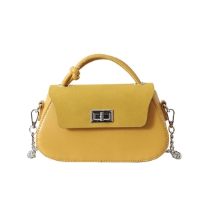 Yellow saddle bag with mixed textures, metallic twist lock, and elegant chain strap