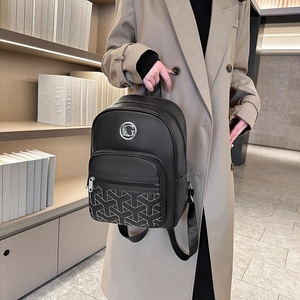 Women's black quilted backpack with geometric Y-pattern pocket and metallic logo