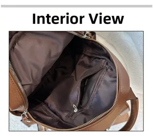 Interior view of brown leather backpack featuring a secure metal zipper pocket and lining