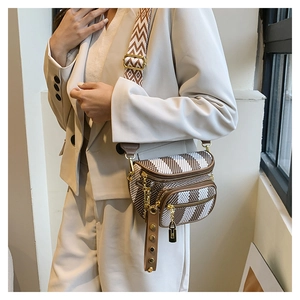 Close-up of retro crossbody chest bag featuring wavy stripes and multiple zipper pockets