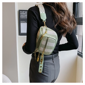 Detail of mint green crossbody bag featuring geometric texture and woven strap
