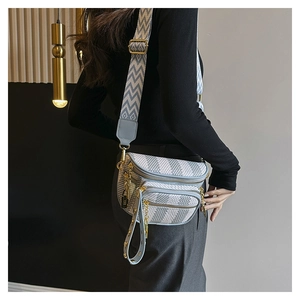 Detail of multi-layer zipper cross-body bag with light blue pattern and wide strap