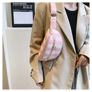 Detail of pink and white checkered half-moon chest bag with wide woven strap on model