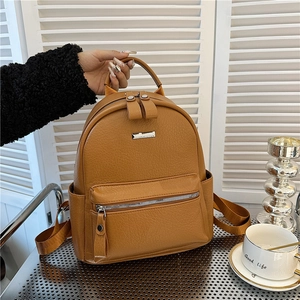 Classic brown pebble leather backpack for women with front zipper pocket and top handle