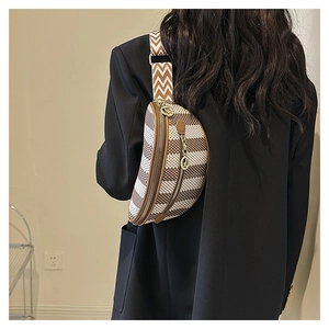 Close-up of geometric pattern crossbody bag with wide woven strap and metal zipper