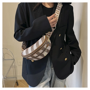 Close-up of a checkered crossbody chest bag with decorative metal pendant and wavy strap