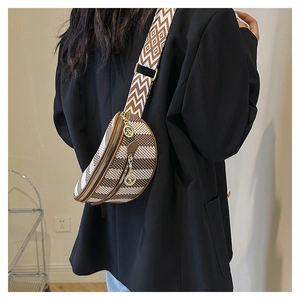 Close-up of stylish fabric waist bag with geometric patterns and ethnic woven strap