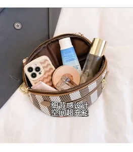 Top view of checkered crossbody bag showing spacious interior with dual zipper opening