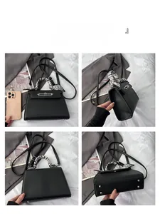 Detailansicht der schwarzen Handtasche aus Narbenleder mit Seidentuch und Silberverschluss