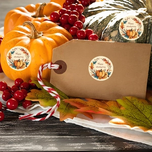 Close-up of Happy Thanksgiving pumpkin stickers on kraft tags and seasonal decor