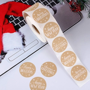 Kraft paper New Year stickers on a laptop with festive Christmas decor, roll view