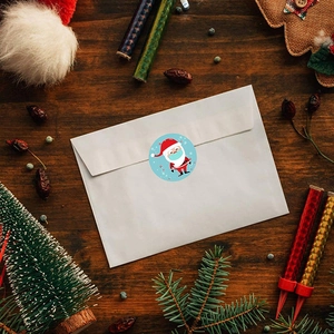 Christmas Santa sticker seal on white envelope with festive wooden background décor