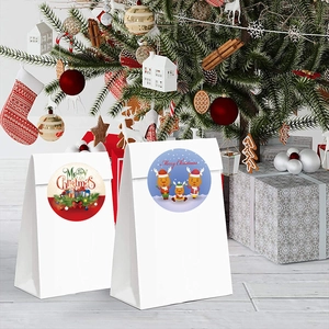 Merry Christmas gift bags with reindeer stickers placed under a decorated tree