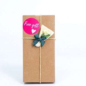 Kraft paper gift box with dried flowers and magenta Free Gift sticker label