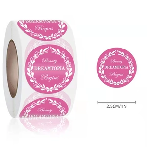2.5cm round pink adhesive labels with white floral border and Beauty DREAMTOPIA Begins text