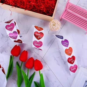 Glitter heart stickers roll for Valentine's Day gift wrapping with Love text design