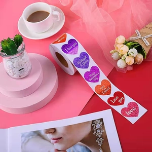 Glittery heart-shaped Valentine's Day stickers on a roll for gift wrapping and decoration