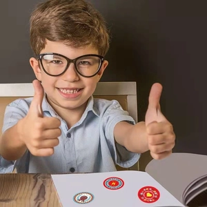 Colorful graduation season stickers for kids featuring medal and heart designs on a laptop