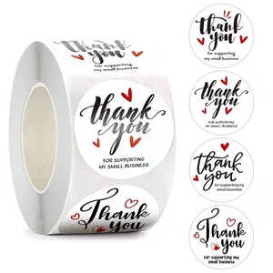 Roll of white circular Thank You stickers with black script and red hearts for small business