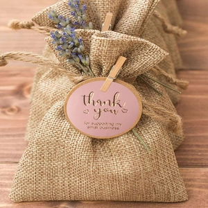 Pink and gold foil Thank You stickers on burlap bags with wooden clips and dried lavender