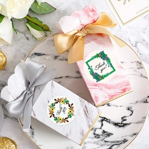 Floral Thank You stickers on marble gift boxes with satin ribbons for wedding favors